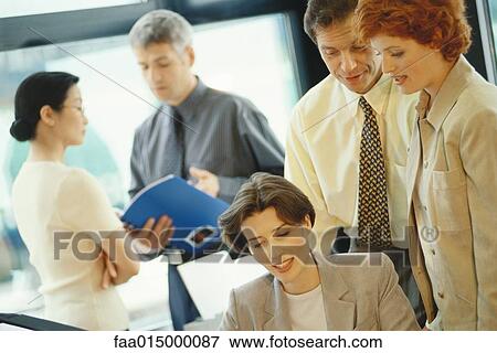 Business colleagues interacting in office View Large Photo Image Stock Photo - Business colleagues interacting in office. Fotosearch