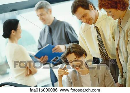 Business colleagues interacting in office View Large Photo Image Stock Photograph - Business colleagues interacting in office. Fotosearch