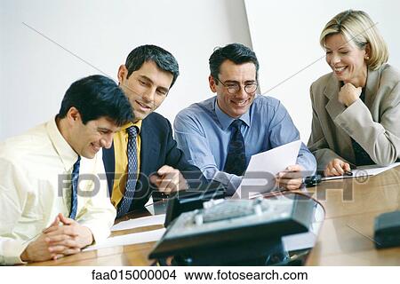 Picture - Business colleagues sitting in meeting, smiling. Fotosearch