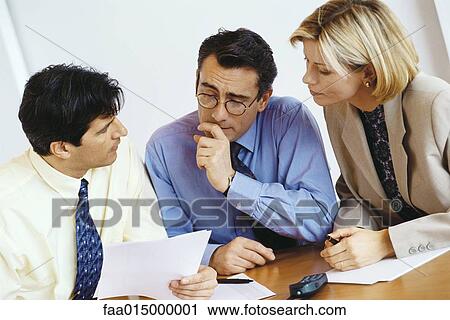 Business colleagues studying document View Large Photo Image Stock Image - Business colleagues studying document. Fotosearch
