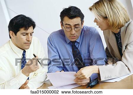 Business colleagues studying document View Large Photo Image Stock Image - Business colleagues studying document. Fotosearch