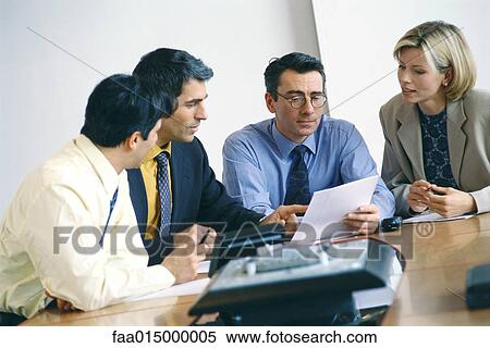 Business colleagues studying document View Large Photo Image Stock Photography - Business colleagues studying document. Fotosearch