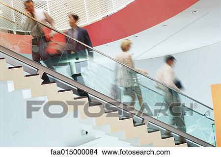 Business executives going up and down staircase View Large Photo Image Picture - Business executives going up and down staircase. Fotosearch