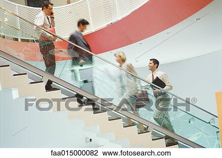 Business executives going up and down staircase View Large Photo Image Stock Image - Business executives going up and down staircase. Fotosearch