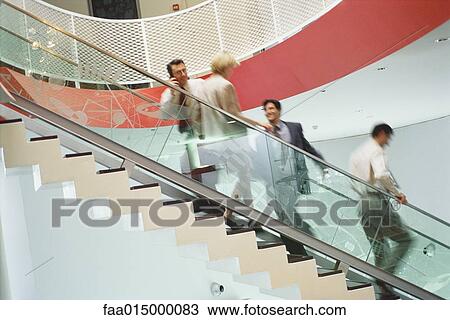 Business executives going up and down staircase View Large Photo Image Stock Image - Business executives going up and down staircase. Fotosearch