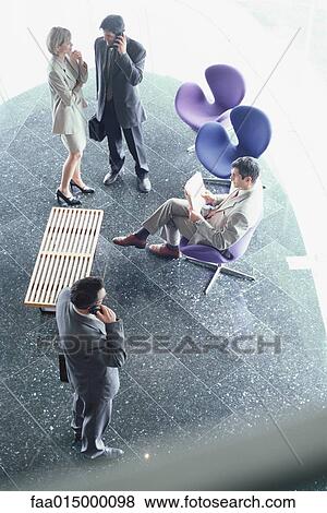 Business executives in lobby, high angle view View Large Photo Image Stock Photo - Business executives in lobby, high angle view. Fotosearch