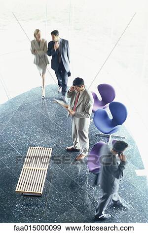 Business executives in lobby, high angle view View Large Photo Image Stock Photo - Business executives in lobby, high angle view. Fotosearch