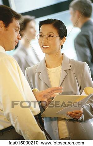 Stock Image - Business executives interacting. Fotosearch