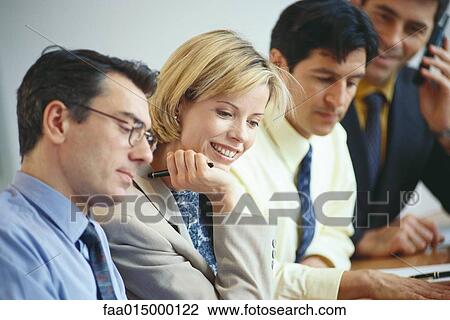 Business executives sitting together, laughing View Large Photo Image Stock Image - Business executives sitting together, laughing. Fotosearch