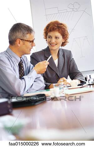 Business executives talking at conference table View Large Photo Image Stock Photograph - Business executives talking at conference table. Fotosearch