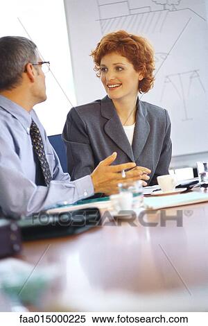 Business executives talking at conference table View Large Photo Image Stock Photography - Business executives talking at conference table. Fotosearch