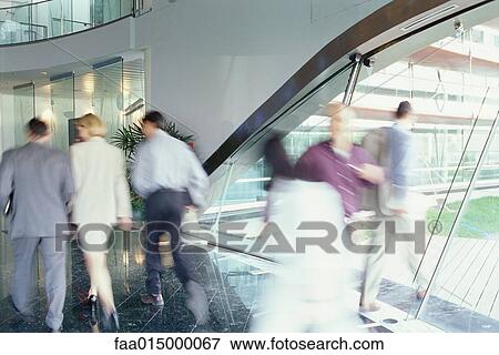 Business executives walking in lobby, blurred motion View Large Photo Image Stock Photo - Business executives walking in lobby, blurred motion. Fotosearch