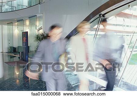 Business executives walking in lobby, blurred motion View Large Photo Image Stock Photo - Business executives walking in lobby, blurred motion. Fotosearch