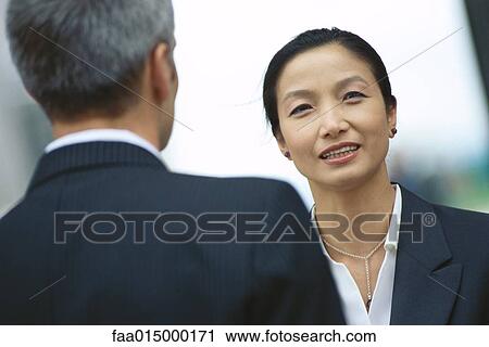 Business partners talking, face to face View Large Photo Image Stock Image - Business partners talking, face to face. Fotosearch