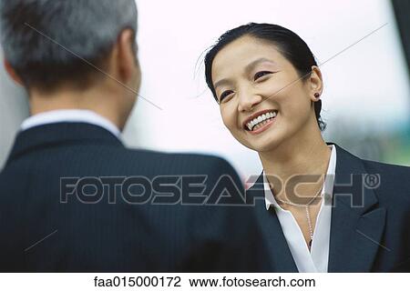 Business partners talking, face to face View Large Photo Image Stock Image - Business partners talking, face to face. Fotosearch