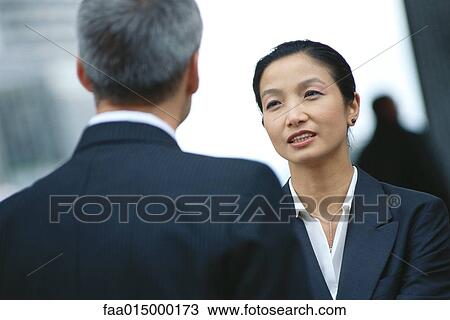 Business partners talking, face to face View Large Photo Image Stock Image - Business partners talking, face to face. Fotosearch