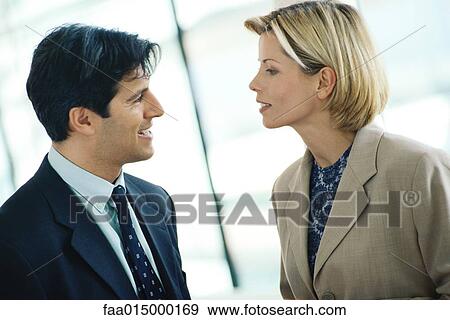 Businessman and woman talking, face to face View Large Photo Image Stock Photo - Businessman and woman talking, face to face. Fotosearch