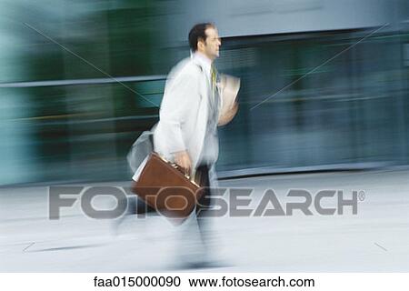 Businessman running with briefcase View Large Photo Image Stock Image - Businessman running with briefcase. Fotosearch
