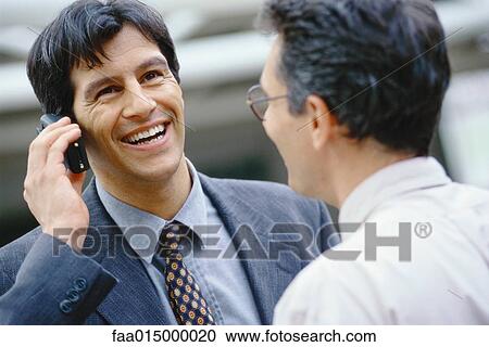 Businessman using phone, colleague facing him, head and shoulders View Large Photo Image Stock Image - Businessman using phone, colleague facing him, head and shoulders. Fotosearch