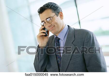 Businessman using phone View Large Photo Image Stock Photography - Businessman using phone. Fotosearch