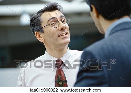 Businessmen talking face to face, head and shoulders View Large Photo Image Stock Image - Businessmen talking face to face, head and shoulders. Fotosearch