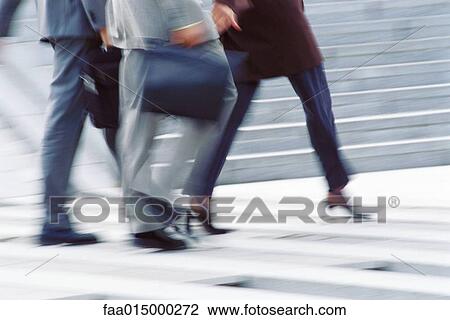 Businesspeople crossing street, low section View Large Photo Image Stock Image - Businesspeople crossing street, low section. Fotosearch