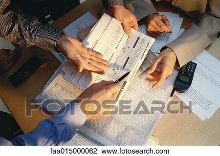 Businesspeople gesturing across table to financial pages of newspaper, cropped view View Large Photo Image Stock Image - Businesspeople gesturing across table to financial pages of newspaper, cropped view. Fotosearch