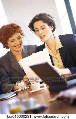 Businesswoman discussing document View Large Photo Image Stock Image - Businesswoman discussing document. Fotosearch
