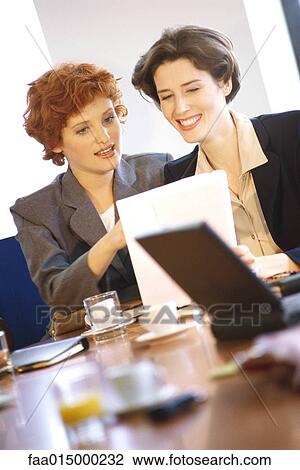 Businesswoman discussing document View Large Photo Image Stock Image - Businesswoman discussing document. Fotosearch