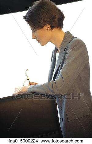 Businesswoman leaning on back of office chair, looking away View Large Photo Image Picture - Businesswoman leaning on back of office chair, looking away. Fotosearch