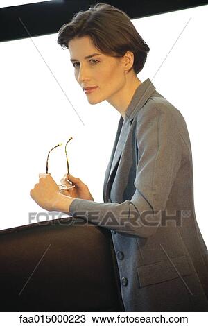 Businesswoman leaning on back of office chair, looking away View Large Photo Image Stock Image - Businesswoman leaning on back of office chair, looking away. Fotosearch