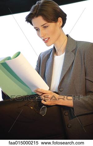 Businesswoman studying document View Large Photo Image Stock Photography - Businesswoman studying document. Fotosearch