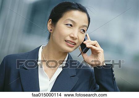 Businesswoman using cell phone View Large Photo Image Picture - Businesswoman using cell phone. Fotosearch