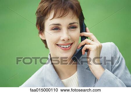 Businesswoman using cell phone View Large Photo Image Stock Image - Businesswoman using cell phone. Fotosearch