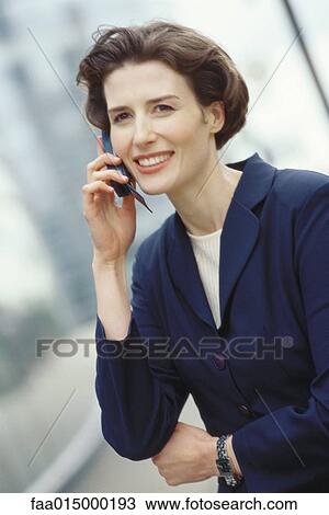 Businesswoman using cell phone View Large Photo Image Stock Image - Businesswoman using cell phone. Fotosearch