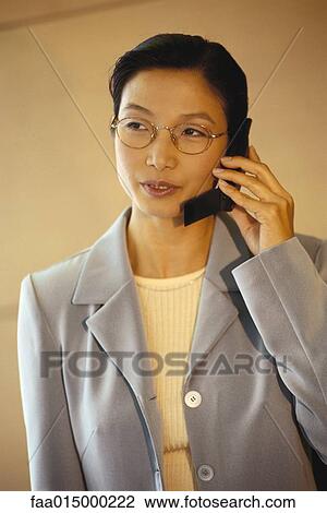 Businesswoman using cell phone View Large Photo Image Stock Image - Businesswoman using cell phone. Fotosearch