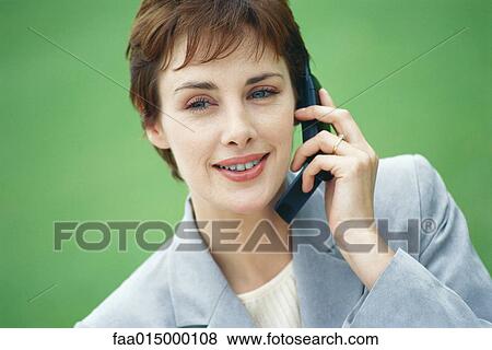 Businesswoman using cell phone View Large Photo Image Stock Photo - Businesswoman using cell phone. Fotosearch