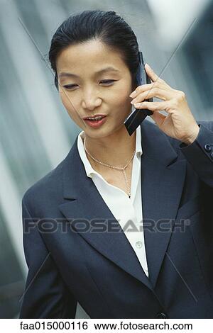 Stock Photograph - Businesswoman using cell phone. Fotosearch