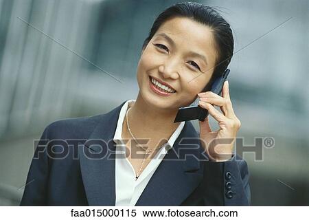 Businesswoman using cell phone View Large Photo Image Stock Photography - Businesswoman using cell phone. Fotosearch