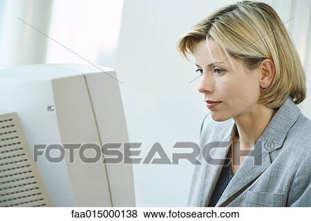 Businesswoman using desktop computer View Large Photo Image Stock Photo - Businesswoman using desktop computer. Fotosearch