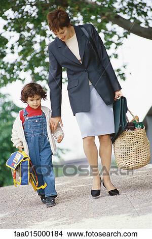 Businesswoman walking with son View Large Photo Image Picture - Businesswoman walking with son. Fotosearch