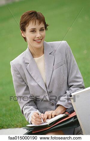 Businesswoman writing in agenda View Large Photo Image Stock Image - Businesswoman writing in agenda. Fotosearch