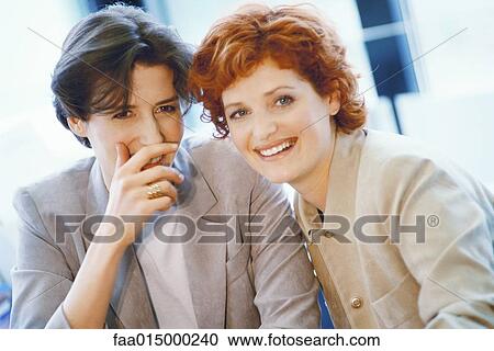 Businesswomen whispering View Large Photo Image Stock Image - Businesswomen whispering. Fotosearch