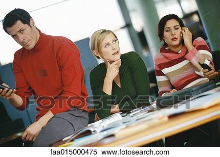 Colleagues sitting around table View Large Photo Image Stock Photography - Colleagues sitting around table. Fotosearch