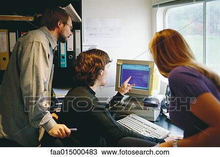 Colleagues working at computer together View Large Photo Image Stock Image - Colleagues working at computer together. Fotosearch