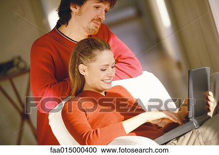 Couple using laptop View Large Photo Image Stock Image - Couple using laptop. Fotosearch