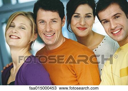 Stock Image - Four young adults, casually dressed, portrait. Fotosearch