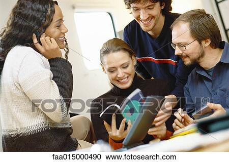 Four young colleagues working together View Large Photo Image Stock Image - Four young colleagues working together. Fotosearch