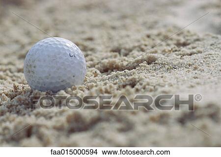 Golf ball in sand, close-up View Large Photo Image Picture - Golf ball in sand, close-up. Fotosearch