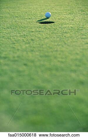 Golf ball near hole View Large Photo Image Stock Photo - Golf ball near hole . Fotosearch